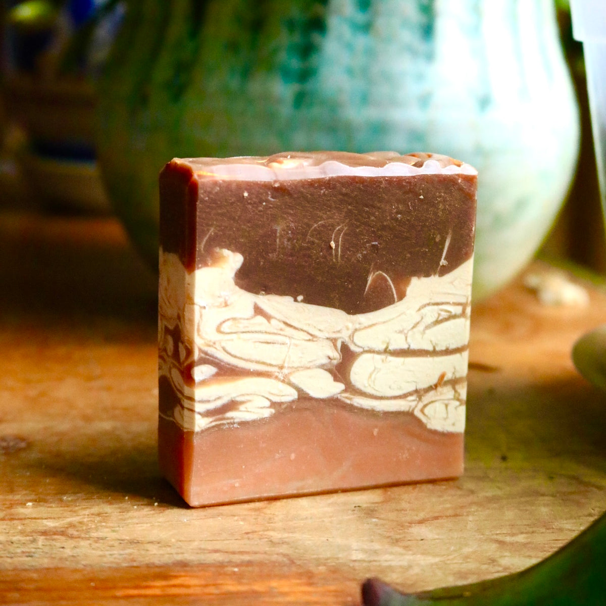 Vegan, plant-based Chai Tea bar soaps, with a brown base, mottled and swirled white midsection with brown streaks, and a dark brown top.