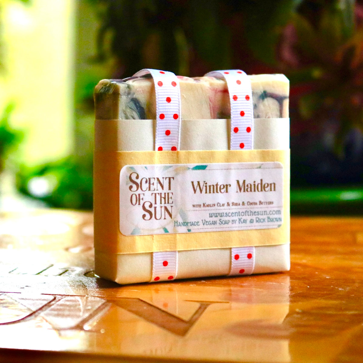 Wrapped vegan, plant-based Winter Maiden soap with polka dot-spotted white ribbon and paper covering. 