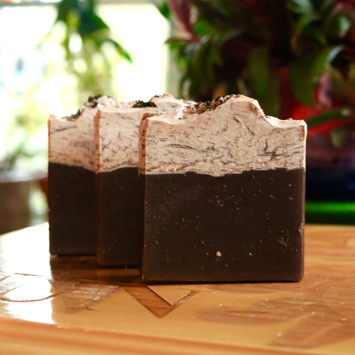 Three bars of plant-based, vegan Caffe Mocha soap in a diagonal row, seen from in front.